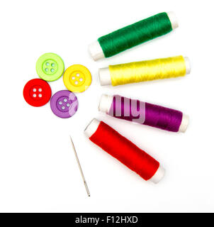 sewing buttons and needle with thread isolated on white Stock Photo