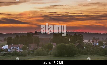Beautiful and spectacular sunset sky over calm countryside. Polish rural landscape Stock Photo