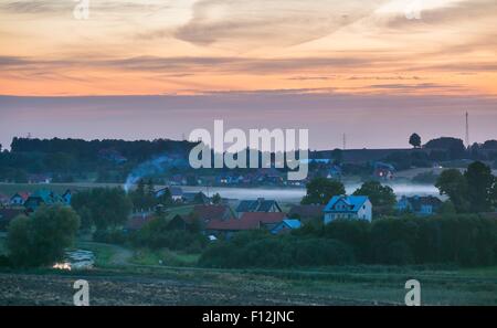 Beautiful and spectacular sunset sky over calm countryside. Polish rural landscape Stock Photo