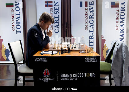 St. Louis, Missouri, USA. 25th Aug, 2015. The world's number one-ranked player, GM MAGNUS CARLSEN, plays his way to a win against GM Maxime-Vachier Lagrave on day three of the third annual Sinquefield Cup at the Chess Club and Scholastic Center of St. Louis. Ten of the world's top chess grandmasters are competing for more than one million dollars in prize money in this year's cup, the second stop on the inaugural, three-tournament Grand Chess Tour. For the first time ever, the United States is being represented by three players ranked in the top ten: Hikaru Nakamura, Fabiano Caruana and We Stock Photo