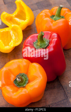 organic red, yellow, and orange bell peppers Stock Photo