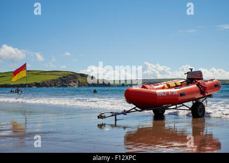 RNLI lifeguards on patrol during the summer holidays on the sandy beach at Bigbury-on-sea in south Devon UK Stock Photo