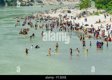 Pilgrims are taking bath at the banks of the holy river Ganges, Rishikesh, Uttarakhand, India Stock Photo