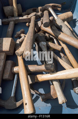 A selection of old hammers and mallets in a box at a car boot sale Stock Photo