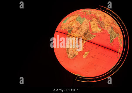 MILAN, ITALY - DECEMBER 17, 2014: red light world globe illuminated from within Stock Photo