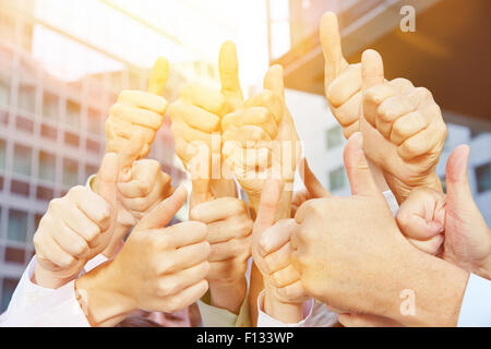 Manny winner holding their thumbs up after a victory in summer Stock Photo