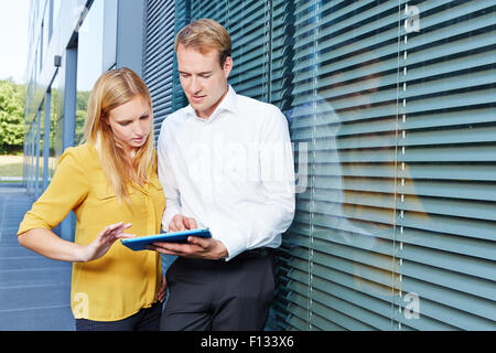Young business people working with a tablet computer in the city Stock Photo