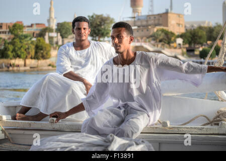 Egyptian sailing men, sailing a traditional felucca in Aswan, Egypt, Africa Stock Photo