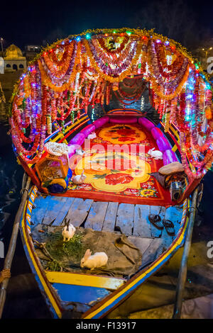 Highly decorated rowing boat with holy rabbits on the Mandakini River, Chitrakoot, (Chitrakut), Madhya Pradesh, India Stock Photo