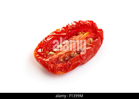 Sun dried tomato half isolated on white with smooth shadow. Large depth of field Stock Photo