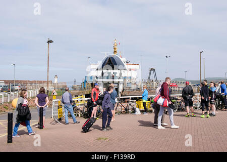 Cyclists and foot passengers waiting for the Arran ferry at the terminal in port of Ardrossen, South Ayrshire, Scotland, UK Stock Photo