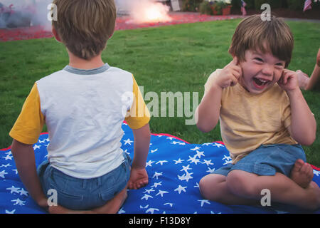 Two children enjoying fireworks display Stock Photo