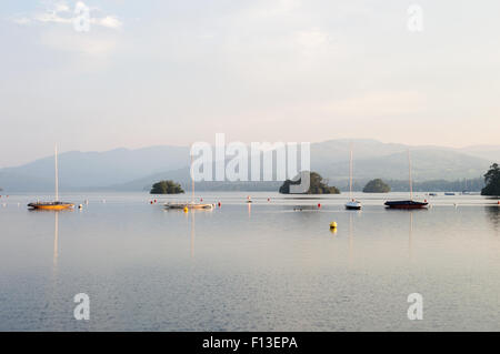 Small boats early on a Summer's morning moored on Lake Windermere, the Lake District, England Stock Photo