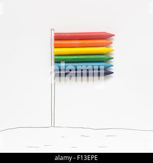 Colorful rainbow gay pride flag being waved in the breeze by a hand ...