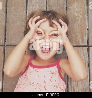 Girl looking through finger frames Stock Photo