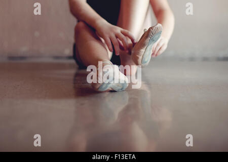 Close-up of a girl putting on ballet shoes Stock Photo