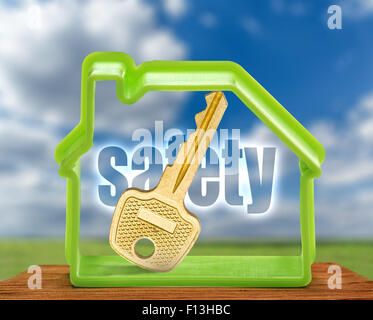 Toy house form with key as symbol outdoors Stock Photo