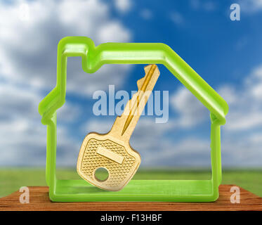 Toy house form with key as symbol outdoors Stock Photo