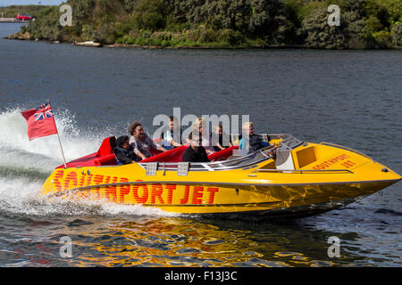 Southport, Merseyside, UK 26th August, 2015.  UK Weather. Passengers on 650-horsepower jet boat enjoying lakeside activities in sunny but blustery conditions after heavy rain with concessionaires busy with tourists, day-trippers and holidaymakers enjoying the attractions.  At Marine Lake there are water based activities to keep the whole family entertained, including pedalos, yacht sailing and motor boats for hire as well as high speed rides on a power jet boat. The Marine Lake and boating area, and leisure ,lakes. Stock Photo