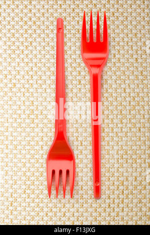Red plastic forks vertical in close up Stock Photo