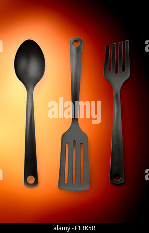 Kitchen utensil collection set of three on orange Stock Photo