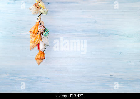 Seashells and sand on wooden board Stock Photo
