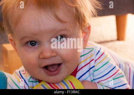 Blonde baby boy playing in nursery Stock Photo