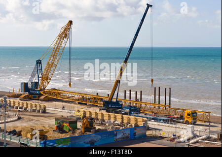 construction site - Cranes assemble a giant crane in readiness to build the Brighton i360 viewing platform on the seafront at Brighton East Sussex England UK Stock Photo