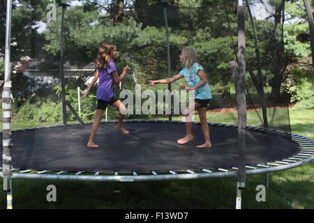 Two girls on trampoline Stock Photo