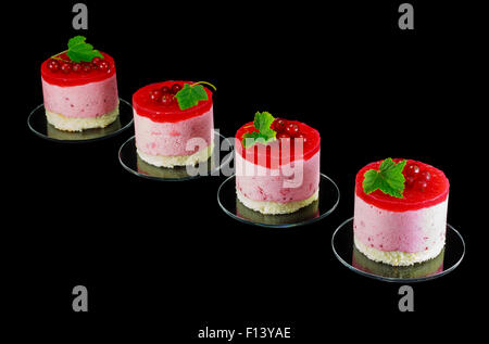 Four small redcurrant cakes decorated with berries Stock Photo
