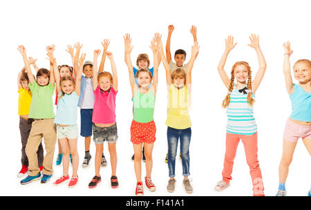 Kids stand together boys and girls rise hands Stock Photo