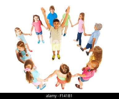 Asian boy in circle of other kids Stock Photo