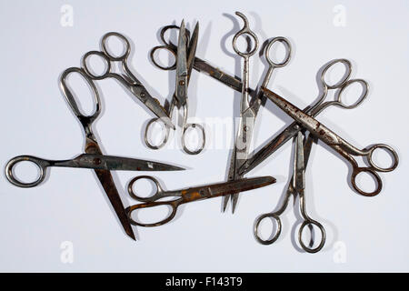 Old scissors on a white table. Stock Photo