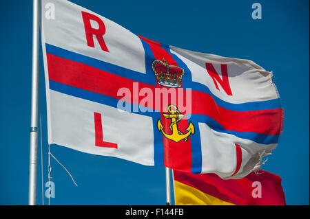 The Royal National Lifeboat Institution flag flying in the wind in Portsmouth Stock Photo