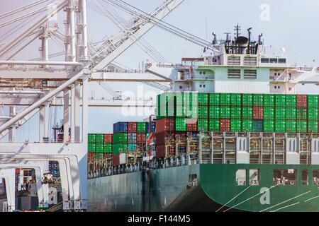 Unloading Cargo Ship in Port. International Shipping Destinations Theme. Stock Photo