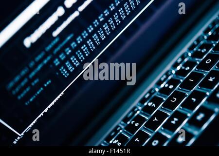 Password Hacking Concept Photo. Laptop Computer and Password Hacking Algorithm on the Computer Screen Stock Photo