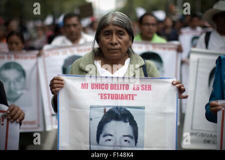 Mexico City, Mexico. 26th Aug, 2015. A relative takes part in the march for the eleven months of the disappearance of 43 students of the Normal Rural School 'Raul Isidro Burgos' of Ayotzinapa, state of Guerrero, in Mexico City, capital of Mexico, on Aug. 26, 2015. Relatives of the missing students took part in a march on Wednesday, one month before the first anniversary of their disappearance. Credit:  Alejandro Ayala/Xinhua/Alamy Live News Stock Photo