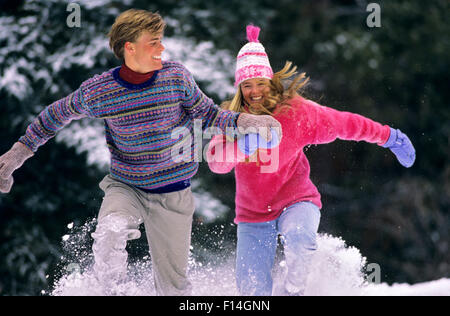 COUPLE RUNNING IN SNOW VAIL COLORADO Stock Photo