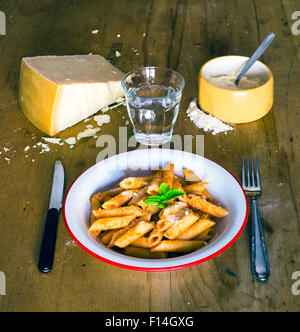 traditional italian pasta named penne rigate, cooked with tomato sauce and parmigiano cheese Stock Photo