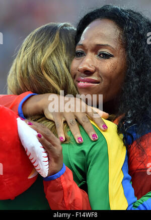 Beijing, China. 27th Aug, 2015. Gold medalist Cuba's Yarisley Silva (R) hugs with silver medalist Brazil's Fabiana Murer during the women's pole vault awarding ceremony at the IAAF World Championships at the 'Bird's Nest' Naitonal Stadium in Beijing, capital of China, Aug. 27, 2015. Credit:  Li Wen/Xinhua/Alamy Live News Stock Photo