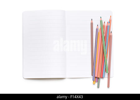 colored pencils and open workbook on white background Stock Photo