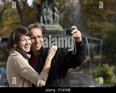 USA, New York City, Manhattan, Central Park, Mature couple photographing themselves in Central Park Stock Photo