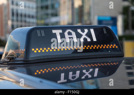 Illuminated sign of a black cab in the city of Brussels, Belgium Stock Photo