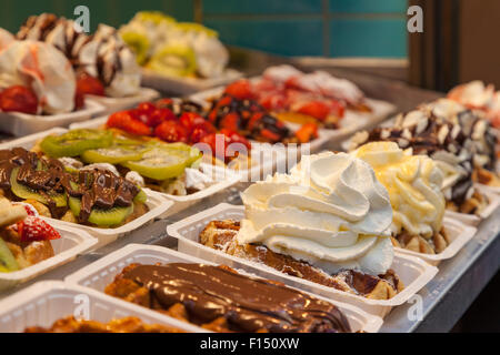 Traditional belgian waffles with several toppings in bakery in Brussels, Belgium Stock Photo