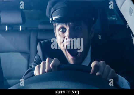 Male chauffeur gets into car crash and makes ridiculous face Stock Photo