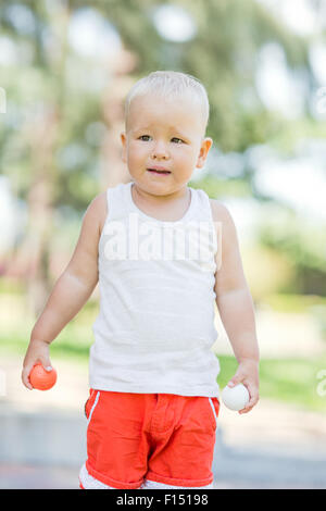 Baby boy playing toy golf outdoor Stock Photo