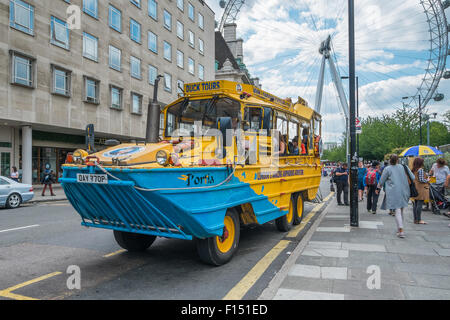 LONDON, UK- JULY 31, 2015: A London Duck Tours sightseeing bus pictured in-front of the London Eye. London Duck tours, using old Stock Photo