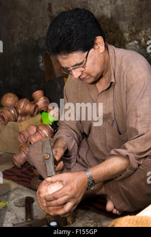 India, Jammu & Kashmir, Srinagar, old city, craftsmanship, metalworker hammering copper bowl into shape Stock Photo