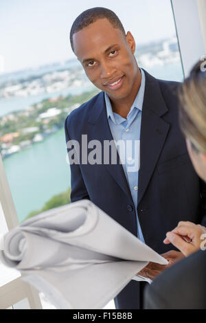 Portrait of a young confident engineer holding blueprint Stock Photo