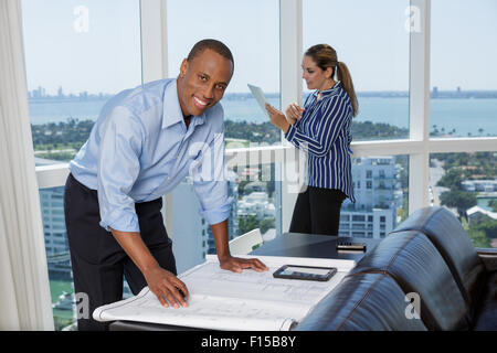 Happy male architect working with his female colleague using digital tablet Stock Photo